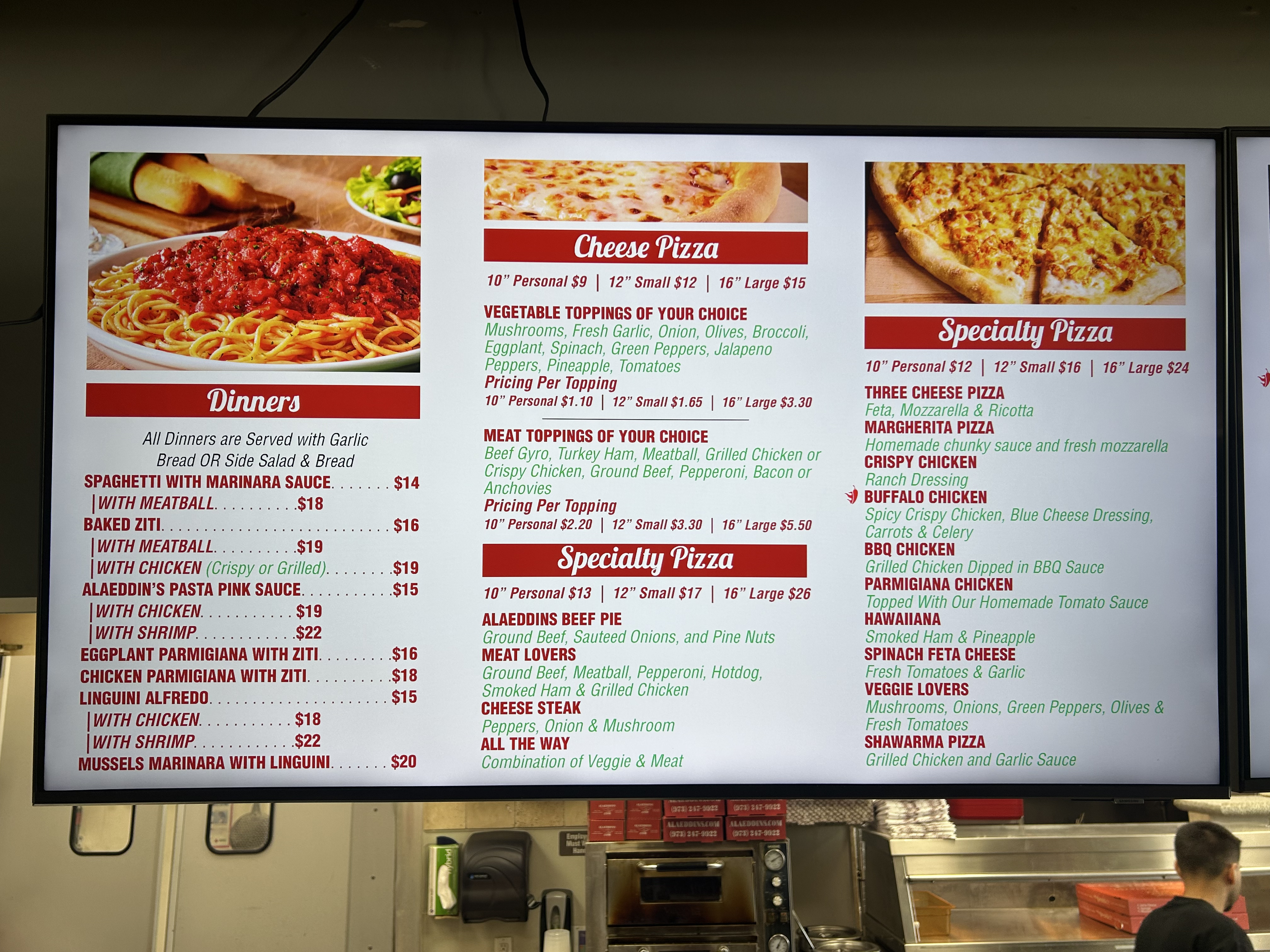The counter and menu screens inside Alaeddin's Pizza at 600 Getty Ave, Clifton NJ